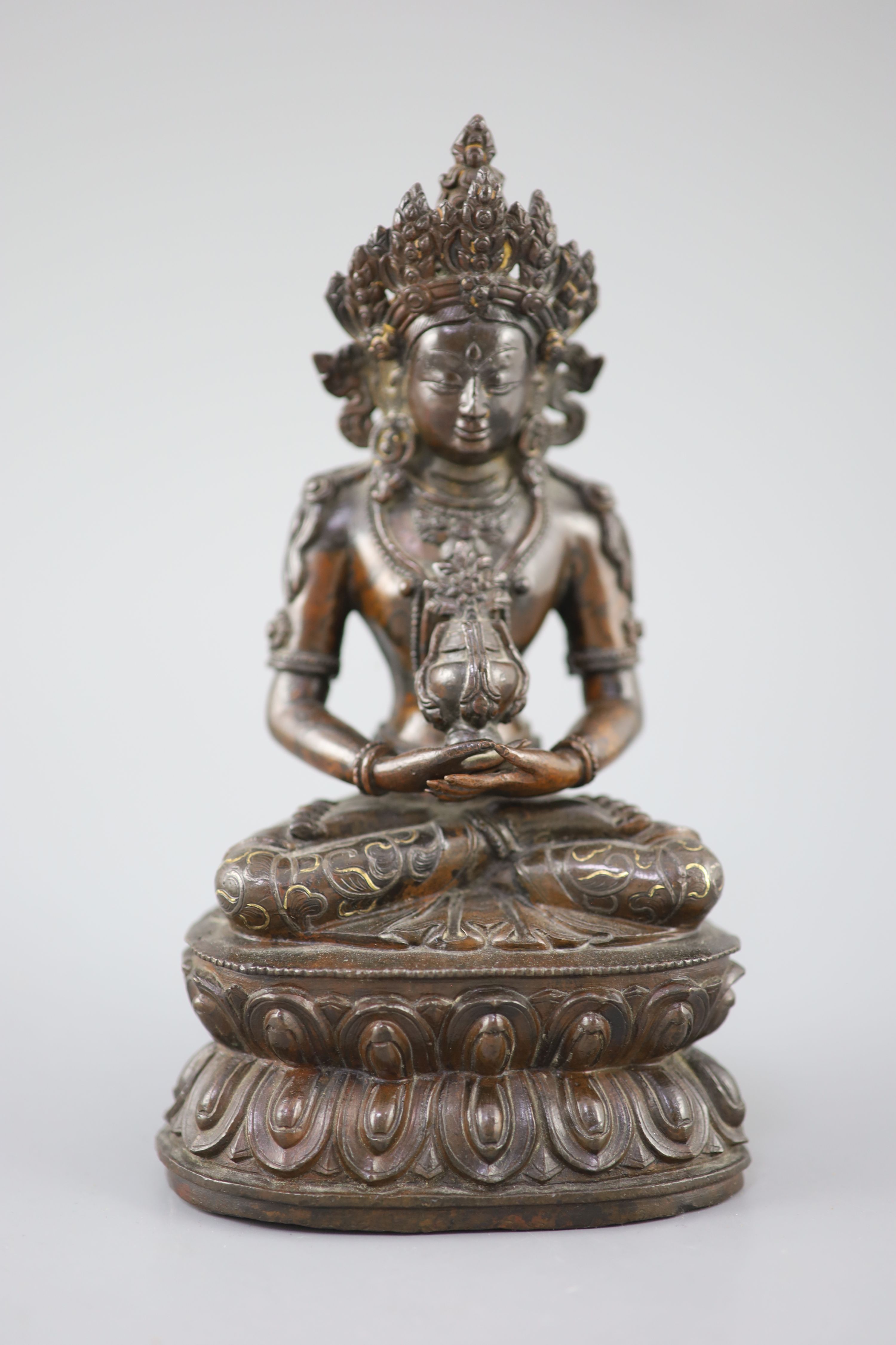 A Tibetan silver and gold inlaid copper alloy figure of Amitayus/Amitabha, c.15th century, 20.5cm high
